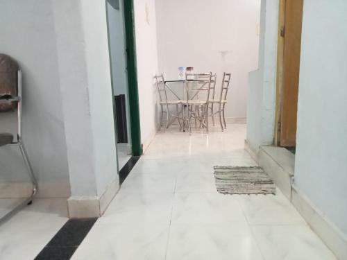an empty hallway with a table and chairs at Hallima Service Apartments Home Stay Purpose Guest House 3 in Pudukkottai