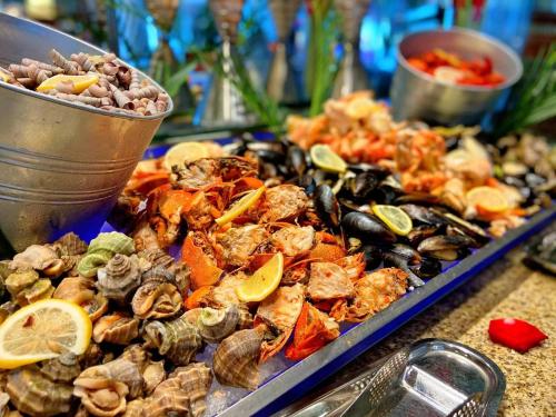 a tray of oysters and mussels on a table at Shangri-La Huhhot in Hohhot