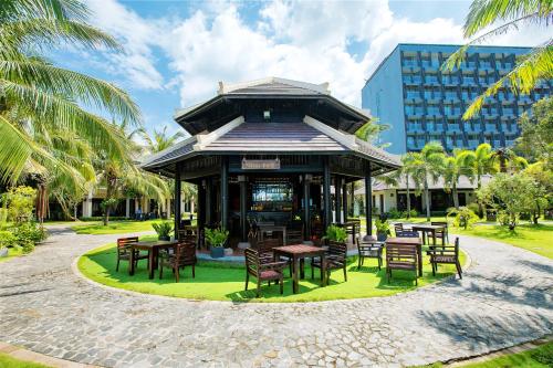 a pavilion with tables and chairs in a park at Anja Beach Resort & Spa in Phu Quoc