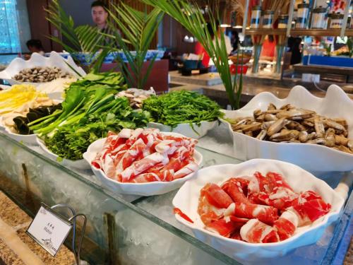 a buffet filled with different types of seafood and vegetables at Shangri-La Huhhot in Hohhot