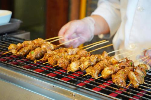 a person is cooking food on a grill at Shangri-La Huhhot in Hohhot