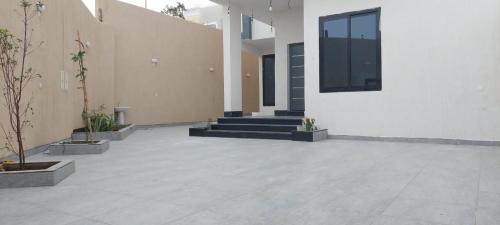 a courtyard of a building with stairs and plants at فيلا الكادي in Al Hada