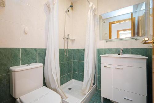 a bathroom with a toilet and a shower and a sink at Alborada Golf 3 1A Spaniahome in Albir