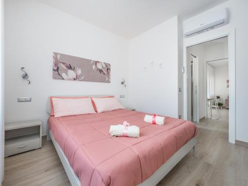 a bedroom with a pink bed with pink sheets at Harmony House in Sorrento coast in Piano di Sorrento