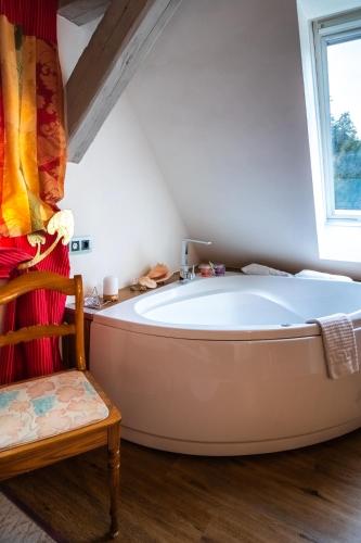 a bath tub in a room with a window at Holzwerk Oybin in Kurort Oybin