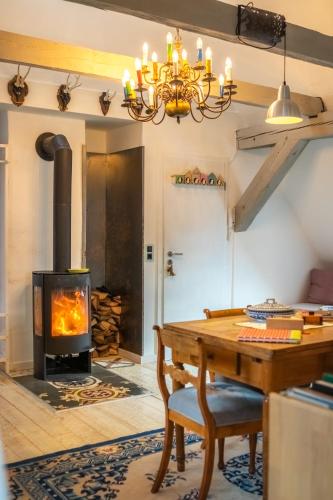 a fireplace in a living room with a wood stove at Holzwerk Oybin in Kurort Oybin