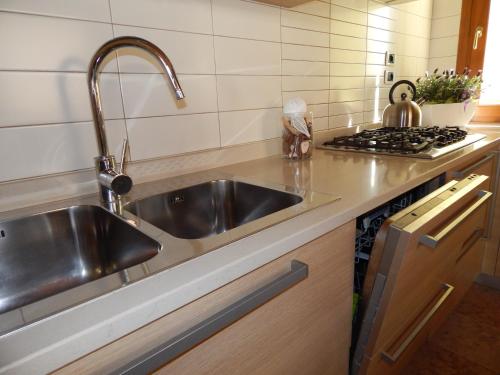 a kitchen with a sink and a stove at Monte Grappa Guest House in Romano D'Ezzelino