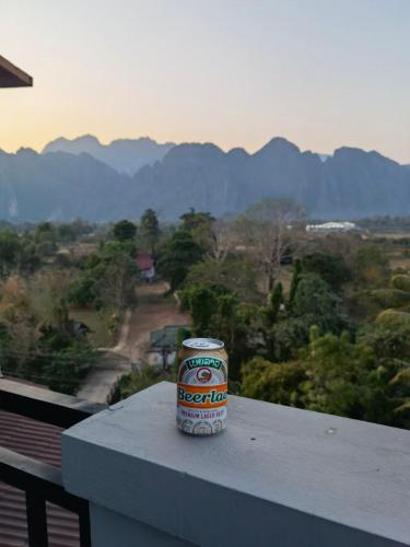 a can of beer sitting on the ledge of a balcony at ChanthaSouk Vang Vieng Entire Villa in Vang Vieng