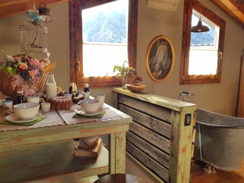 a kitchen with a table and a bath tub at La Bottega del Drago in Santa Brigida