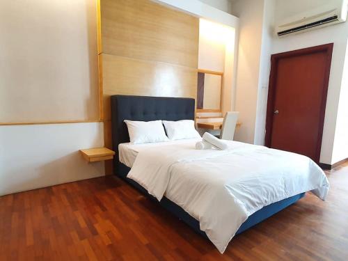 a bedroom with a large bed with white sheets at [HERITAGE 3] HOMESTAY Studio 4Pax, FREE WIFI NETFLIX in Seri Kembangan