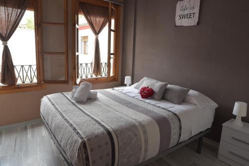 a bedroom with a bed with a stuffed animal on it at Casita Piedra Escrita- Private house in Córdoba