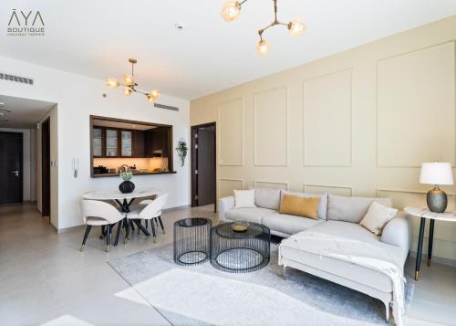 a living room with a couch and a table at Fancy One Bedroom Apartment in Downtown Dubai By ĀYA Boutique in Dubai