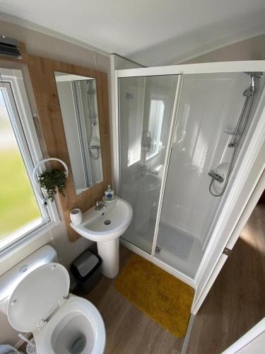 a bathroom with a shower and a toilet and a sink at 3 Bed Static Caravan in Morecambe in Morecambe