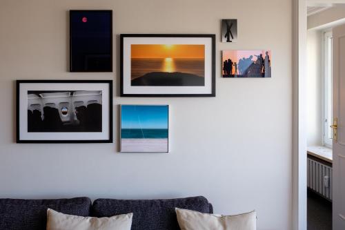 a living room with four pictures on a wall at Sola Bona 24 in Westerland