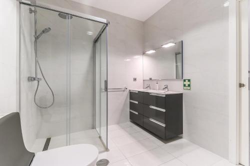 a bathroom with a shower and a toilet and a sink at Vita Portucale ! Moscavide Family Apartment in Lisbon