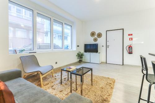 a living room with a couch and a table at Vita Portucale ! Moscavide Family Apartment in Lisbon