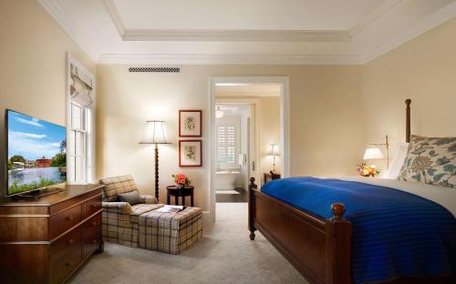 a bedroom with a bed and a television in it at Montage Palmetto Bluff in Bluffton