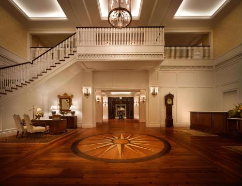 a large lobby with a staircase and a clock at Montage Palmetto Bluff in Bluffton