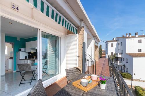 a balcony with a table and chairs on a building at Bella mar in L'Escala