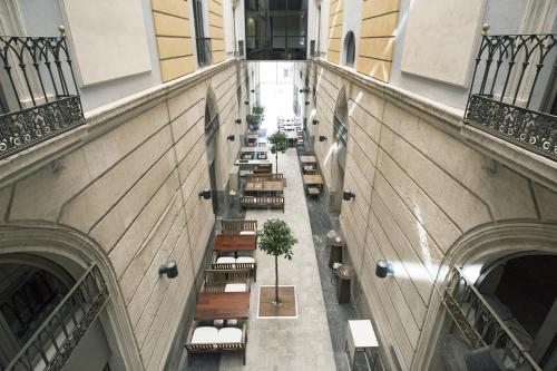 an overhead view of a building with tables and benches at Hospes Amérigo, Alicante, a Member of Design Hotels in Alicante
