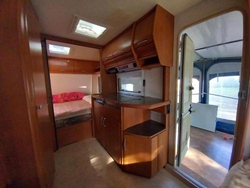 an interior view of an rv with a kitchen and a bedroom at Caravan near the sea 6 in Ugljan