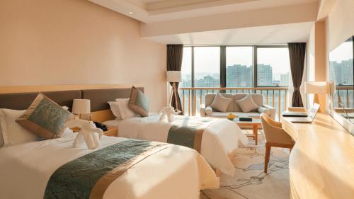 a hotel room with two beds and a balcony at White Swan Guest House MeiZhou in Meizhou