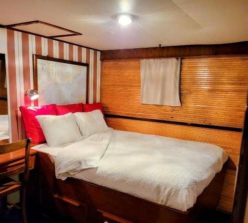 a bed with a wooden head board in a room at Don Maximo Yacht Hotel in Vigo