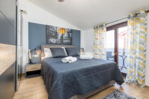 a bedroom with a bed with two towels on it at Wine house apartments & rooms Marčeta in Fažana