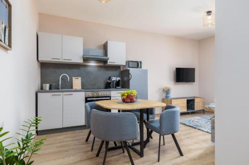 a kitchen and dining room with a table and chairs at Wine house apartments & rooms Marčeta in Fažana