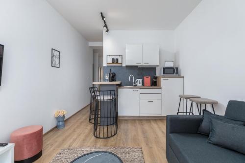 a living room with a couch and a kitchen at Wine house apartments & rooms Marčeta in Fažana