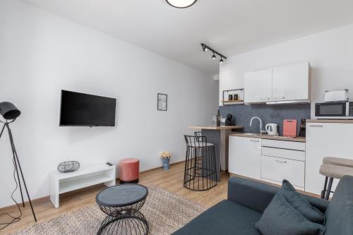 a living room with a couch and a kitchen at Wine house apartments & rooms Marčeta in Fažana