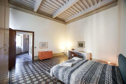 a bedroom with a bed and a desk in it at La Fabbrica in Calci