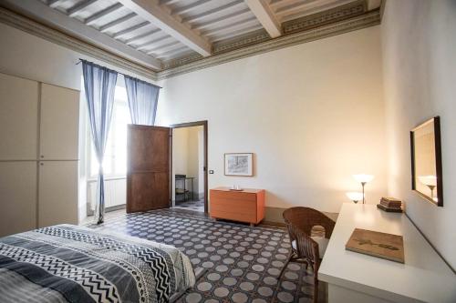 a bedroom with a bed and a table and a desk at La Fabbrica in Calci