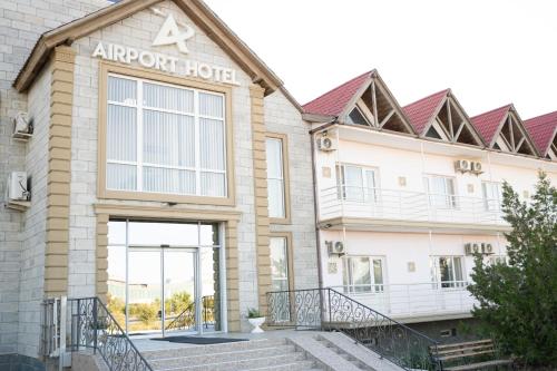 a building with an entrance to an airport hotel at Aktau Airport Hotel in Aktau
