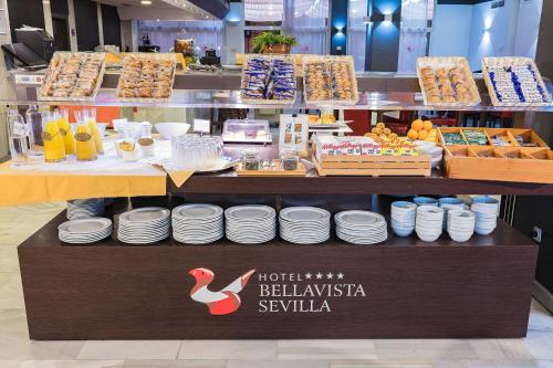 a store with a counter with plates and food at Bellavista Sevilla in Seville
