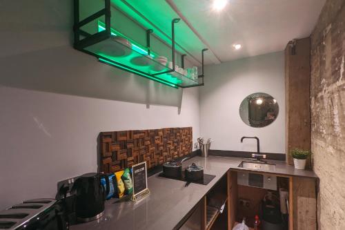 a kitchen with a green light hanging from the ceiling at Blayds Yard in Leeds