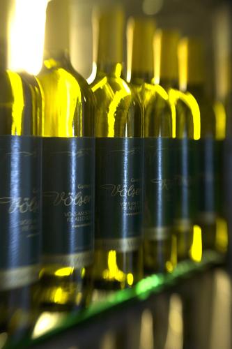 a row of bottles of wine on a shelf at Gartenhotel Völser Hof - Adults Only in Fiè