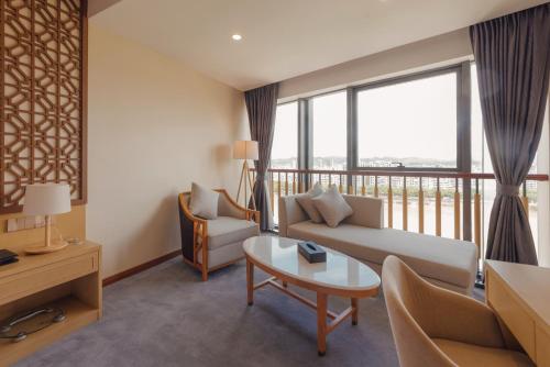 a living room with a couch and a table at White Swan Guest House MeiZhou in Meizhou