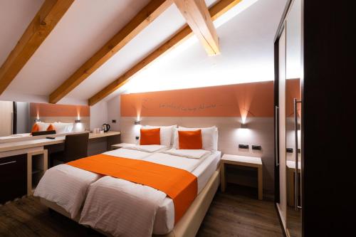 a bedroom with a large bed and a desk at Albergo Casavecchia in Tiarno di Sopra