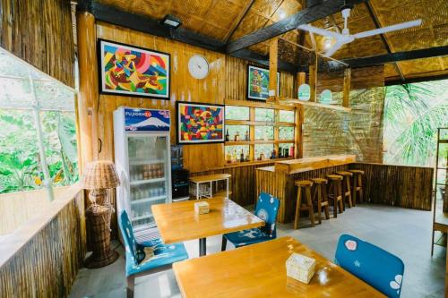 a restaurant with wooden walls and tables and a bar at Vafi Hills Bed And Breakfast in San Isidro