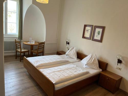 a hotel room with two beds and a table at Kloster Wernberg in Wernberg