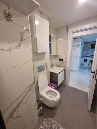 a small bathroom with a toilet and a sink at Royal Exclusive Kleopatra, beach in Alanya