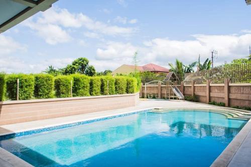 a swimming pool in a yard with a fence at Cozy Place 2BR Condo Unit in Ortigas Ave Ext in Cainta