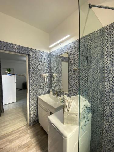 a bathroom with a sink and a toilet and a mirror at Apartament Amy 2 in Mamaia Sat/Năvodari