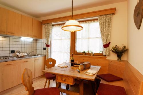 a kitchen with a wooden table and a window at Villa Ortensia in San Vigilio Di Marebbe