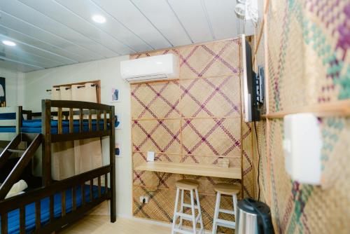 a room with two bunk beds and a wall at Vafi Hills Bed And Breakfast in San Isidro