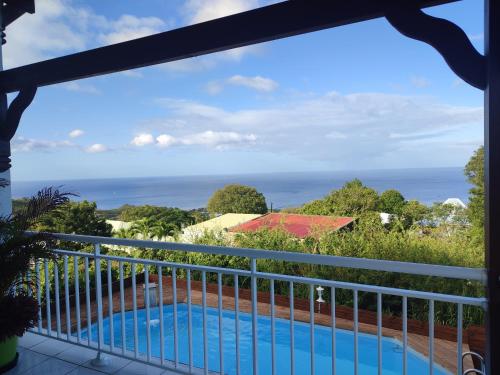 a balcony with a view of the ocean at Villa bébélos in Pointe-Noire