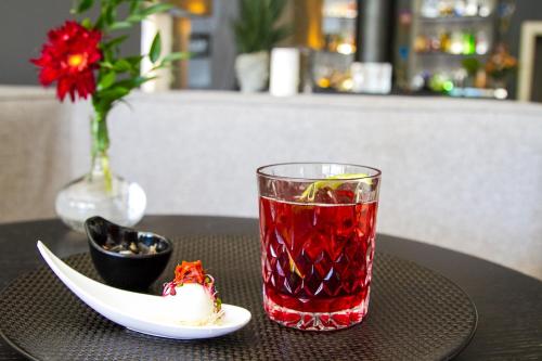 a drink and a plate of food on a table at Grand Hotel Villa Itria Congress & Spa in Viagrande