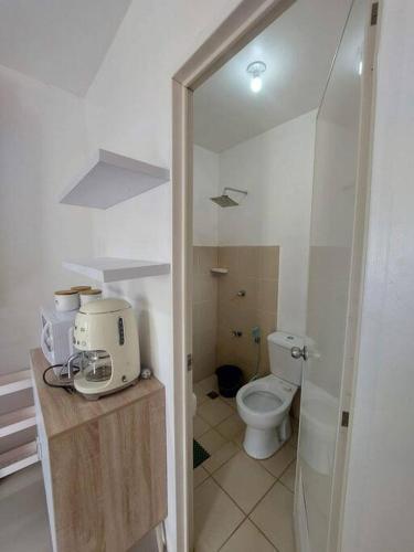 a small bathroom with a toilet and a sink at Cosy House in Bacolod City in Bacolod