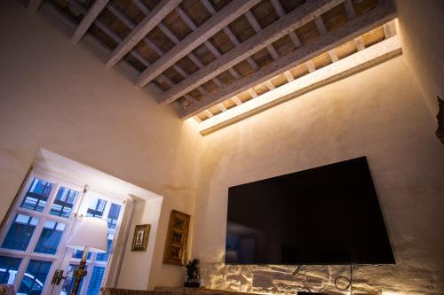 a large flat screen tv on a wall in a room at Apartamentos Sharis in Jerez de la Frontera